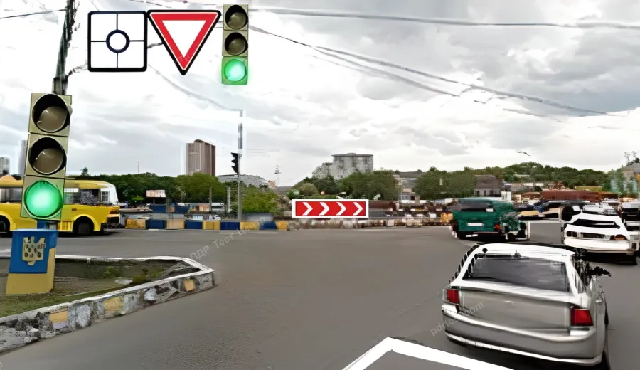 The driver of the grey car is entering a roundabout. Is it necessary in this case to switch on the left turn indicator?